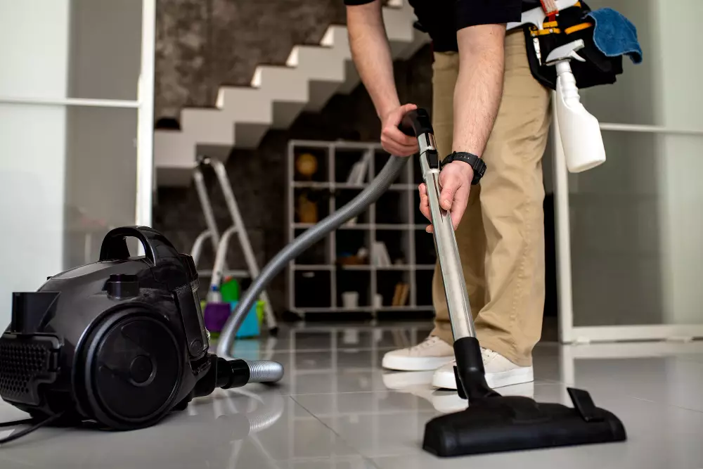 Adelaide cleaner vacuuming a bright living room for a regular home cleaning service